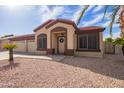 Charming single-Gathering home with a welcoming entrance and a well-maintained desert landscape at 8335 W Berridge Ln, Glendale, AZ 85305