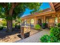 Welcoming brick pathway leading to an arched, ornate front door and landscaped entry at 8649 S Willow Dr, Tempe, AZ 85284