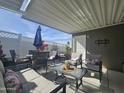 Inviting outdoor patio with comfortable seating, a sun umbrella, and decorative plants, perfect for relaxing at 8700 E University Dr # 1947, Mesa, AZ 85207