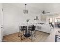 Open-concept living room with dining area, shiplap wall, modern light fixture, and sliding glass door to balcony at 9450 E Becker Ln # 2019, Scottsdale, AZ 85260
