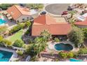 Beautiful aerial view of the property showcasing a private pool and green putting range at 10500 E Mission Ln, Scottsdale, AZ 85258