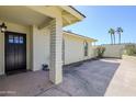 Covered front porch with decorative pillar, and a black front door, offering a welcoming entrance at 1201 E Gemini Dr, Tempe, AZ 85283