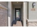 View of the front entrance showing a secure metal gate leading to a brick-paved pathway at 13734 W Harvest Ave, Litchfield Park, AZ 85340