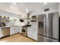 Modern kitchen featuring stainless steel appliances, white cabinetry, open shelving and subway tile backsplash at 1622 N 17Th Ave, Phoenix, AZ 85007
