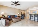 Inviting living room showcasing leather furniture, tile flooring, and an open floor plan at 17228 N Estrella Vista Dr, Surprise, AZ 85374