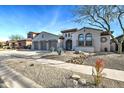 Charming home featuring a well-manicured desert front yard, three-car garage and a welcoming entrance at 2027 W Calle De Las Estrella --, Phoenix, AZ 85085