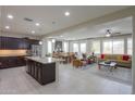 Open floor plan showcasing the kitchen, dining area, and living room filled with natural light at 22651 E Via Del Verde --, Queen Creek, AZ 85142