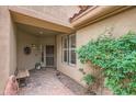 Inviting front entryway with brick pavers, security gate, and lush green landscaping at 2543 W Myopia Dr, Anthem, AZ 85086