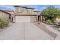 Lovely two story home boasting a charming exterior, three-car garage, and low-maintenance desert landscaping at 26711 N 21St Dr, Phoenix, AZ 85085