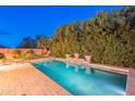 A stunning pool with cool blue water is surrounded by lush greenery and stylish brickwork at 26711 N 21St Dr, Phoenix, AZ 85085