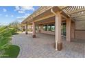 Covered back patio with pavers and decorative pillars offering an excellent space for entertaining at 27248 W Mohawk Ln, Buckeye, AZ 85396