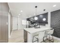 This updated kitchen features modern pendant lights, an island, and stainless appliances at 3002 N 32Nd St # 15, Phoenix, AZ 85018