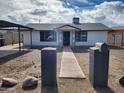 Charming single-story home with desert landscaping, inviting pathway, and classic curb appeal at 3123 W Holly St, Phoenix, AZ 85009