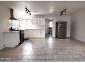 Bright kitchen features white cabinets, stainless steel appliances, and tile flooring at 3123 W Holly St, Phoenix, AZ 85009