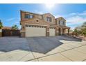 Attractive two-story home featuring a three-car garage, desert landscaping, and a cozy front porch at 41011 W Walker Way, Maricopa, AZ 85138