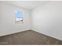 Clean, bright bedroom with neutral carpet, white walls, and a window with blinds at 4351 W Jeanette Ln, San Tan Valley, AZ 85144