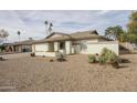 Inviting single-level house featuring desert landscaping, a two-car garage, and a cozy front porch at 4434 W Dahlia Dr, Glendale, AZ 85304