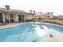 Private backyard oasis with a sparkling pool, comfortable seating, and outdoor dining area at 4434 W Dahlia Dr, Glendale, AZ 85304