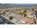 Wide aerial shot showcases the neighborhood, nearby desert landscape and potential pool at 4624 W Heyerdahl Ct, New River, AZ 85087
