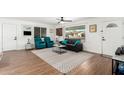 Inviting living room with hardwood floors, comfortable seating, a large window, and neutral décor at 5725 E Colby St, Mesa, AZ 85205