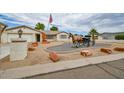 Charming single-story home with desert landscaping, statues, and well-maintained exterior at 6020 E Shea Blvd, Scottsdale, AZ 85254