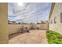 Private backyard patio features tile, a fountain, and chairs at 6614 E Portia St, Mesa, AZ 85215