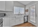 Charming kitchen featuring white cabinets, stainless steel appliances, and a bright window over the sink at 6913 E Kings Ave, Scottsdale, AZ 85254