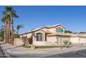 Exterior side view of a charming home with a well-kept lawn, desert landscaping, and a two-car garage at 7452 W Los Gatos Dr, Glendale, AZ 85310