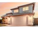 Two-story home featuring a tile roof, arched entryway, stucco siding, and a two-car garage at 7953 W Topeka Dr, Glendale, AZ 85308