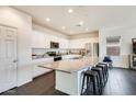 Modern kitchen with large island, stainless steel appliances, and white cabinetry at 12246 W Paso Trl, Peoria, AZ 85383