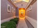 Inviting front entrance with manicured bushes and pathway to the door, with covered entryway at 13102 S 177Th Dr, Goodyear, AZ 85338