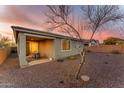 A backyard features desert landscaping and a covered patio with dining set at 13341 W Yearling Rd, Peoria, AZ 85383