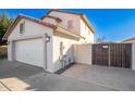 Side view of a two car garage with tile roof and a wooden gate to the backyard at 16161 W Monte Cristo Ave, Surprise, AZ 85374