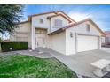 Charming two-story home featuring a two car garage, desert landscaping, and a tile roof at 16161 W Monte Cristo Ave, Surprise, AZ 85374