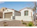 Quaint house with a two-car garage, gated entryway, and desert landscaping at 18248 W Carlota Ln, Surprise, AZ 85387