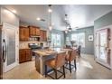 Beautiful kitchen with island seating, stainless steel appliances, and a view into the dining area at 20194 N Riverbank Rd, Maricopa, AZ 85138