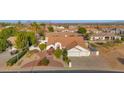 Charming front exterior featuring a well-manicured yard, and a spacious three-car garage at 2020 E Norwood St, Mesa, AZ 85213