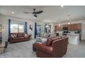 Open-concept living room featuring tile flooring, recessed lighting, and neutral walls and furnishings and a ceiling fan at 20392 W Brittlewood Ave, Buckeye, AZ 85396