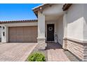 Welcoming entrance with covered porch and decorated front door at 20886 E Sparrow Dr, Queen Creek, AZ 85142