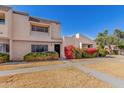 Inviting townhome with well-maintained desert landscaping and vibrant flowering bushes at 2233 W Farmdale Ave # 2, Mesa, AZ 85202