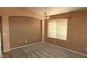 Bright dining room with a modern light fixture and large window for ample natural light at 2303 E Wescott Dr, Phoenix, AZ 85024