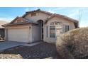 Exterior view of a single-story home with neutral stucco, tile roof, and desert landscaping at 2303 E Wescott Dr, Phoenix, AZ 85024