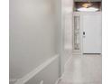 Bright entryway featuring a white front door, tile flooring, and a narrow window with blinds for privacy at 2704 E Anderson Dr, Phoenix, AZ 85032