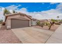 Exterior view of home featuring a desert landscape, a concrete driveway, and an attached two-car garage at 2704 E Anderson Dr, Phoenix, AZ 85032