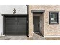 A close-up of a townhome showing the garage, front door, and brick facade details at 2818 W Eagle Talon Rd, Phoenix, AZ 85085