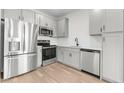 A modern kitchen with stainless steel appliances and gray cabinetry at 2818 W Eagle Talon Rd, Phoenix, AZ 85085