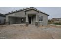 Exterior view of a new build with a two-car garage, stone accents, and a covered front entryway at 37626 N Cowboy Ln, San Tan Valley, AZ 85140