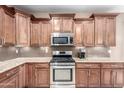 Beautiful kitchen with stainless steel appliances, granite countertops and mosaic tile backsplash at 3790 S Velero St, Chandler, AZ 85286