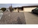 Charming single-story home with low maintenance rock landscaping and attached two car garage at 4026 E Catalina Cir, Mesa, AZ 85206