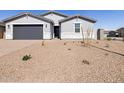 Neat front yard with desert landscaping, complemented by a single-story home with a two-car garage and neutral color scheme at 4812 W Hunter Trl, San Tan Valley, AZ 85144